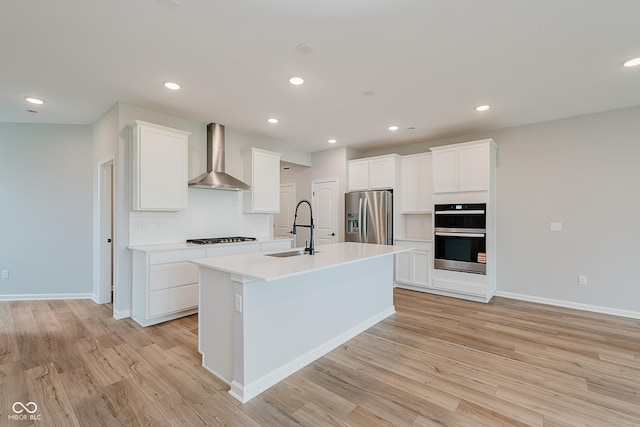 9751 Behner Dr, Fishers, IN 46250 - kitchen featuring appliances with stainless steel finishes, wall chimney exhaust hood, light wood finished floors, light countertops, and recessed lighting