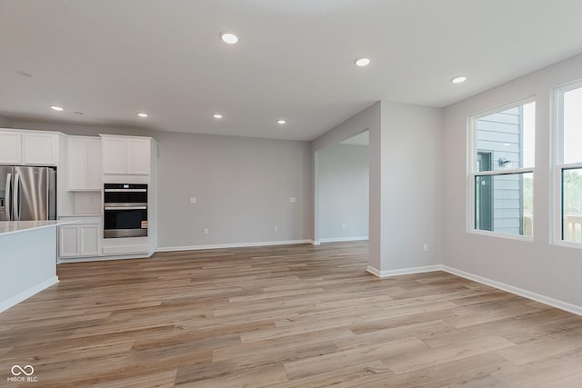 9751 Behner Dr, Fishers, IN 46250 - unfurnished living room featuring light wood-style floors and recessed lighting
