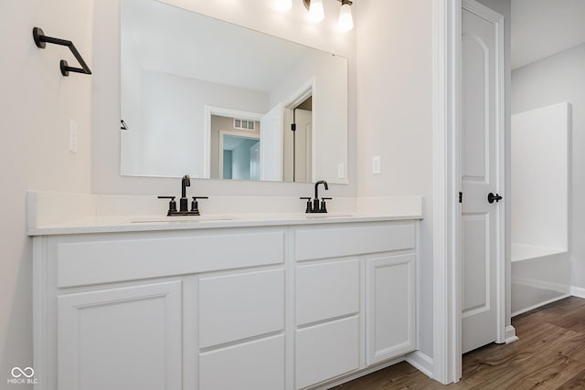 9751 Behner Dr, Fishers, IN 46250 - bathroom featuring double vanity and wood finished floors
