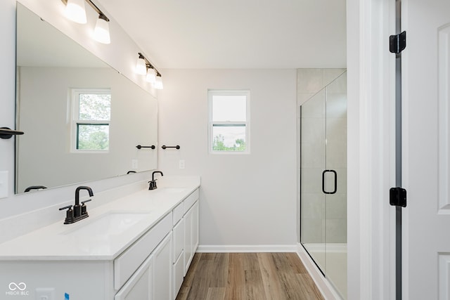 9751 Behner Dr, Fishers, IN 46250 - full bathroom with double vanity, wood finished floors, and a stall shower