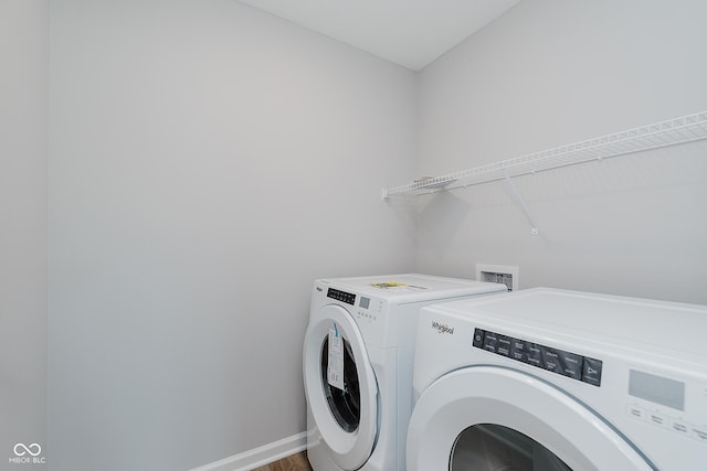 9751 Behner Dr, Fishers, IN 46250 - laundry room featuring washer and clothes dryer and wood finished floors