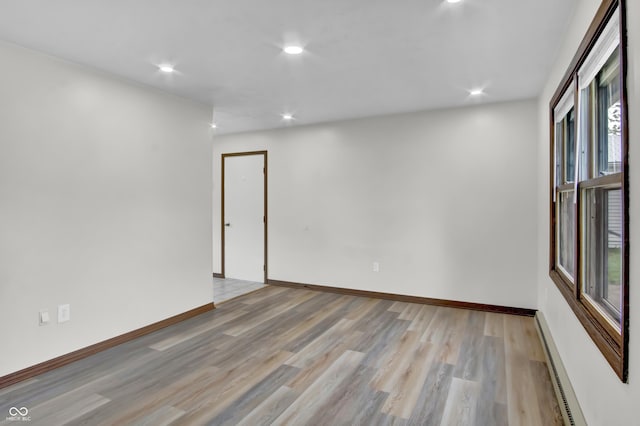 168 Midway Ct S, Hope, IN 47246 - unfurnished room featuring baseboard heating, light wood-style floors, and recessed lighting