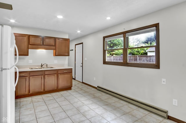 168 Midway Ct S, Hope, IN 47246 - kitchen with baseboard heating, freestanding refrigerator, light countertops, brown cabinetry, and recessed lighting