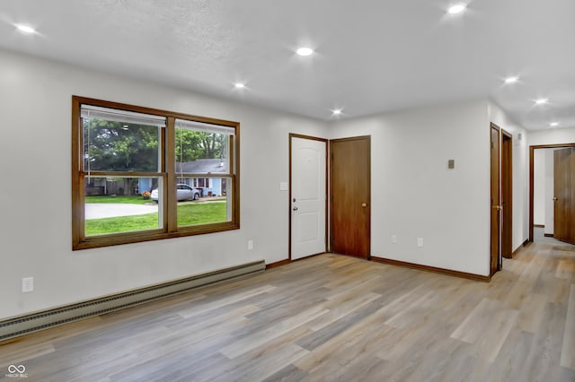 168 Midway Ct S, Hope, IN 47246 - unfurnished room featuring a baseboard heating unit, light wood-type flooring, and recessed lighting