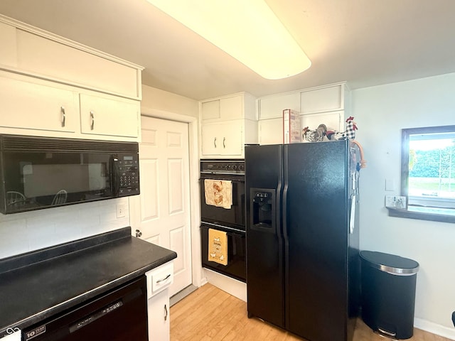 2615 Alexandria Pike, Anderson, IN 46012 - kitchen with black appliances, white cabinetry, light wood-type flooring, and dark countertops