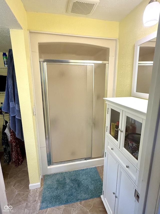 2615 Alexandria Pike, Anderson, IN 46012 - full bathroom featuring a stall shower, a textured ceiling, and tile patterned flooring