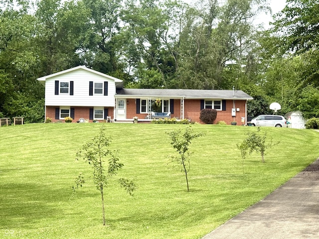 2615 Alexandria Pike, Anderson, IN 46012 - split level home with brick siding, a front yard, and view of scattered trees