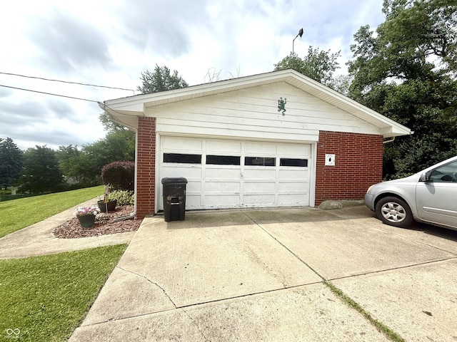 2615 Alexandria Pike, Anderson, IN 46012 - view of side of home featuring brick siding, an outbuilding, a lawn, and a detached garage