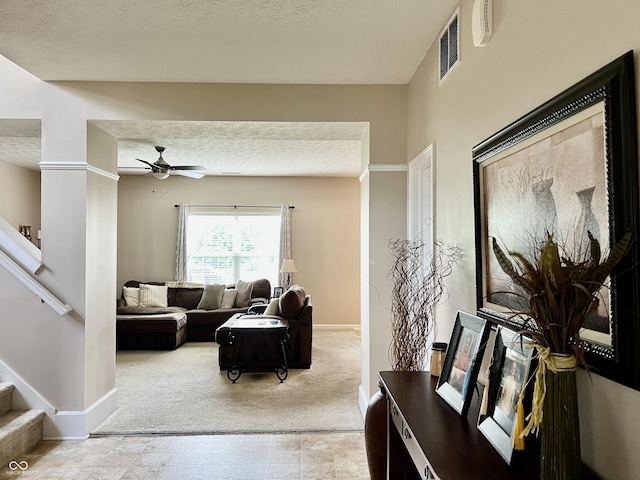 13859 Keams Dr, Fishers, IN 46038 - living area with stairs, light carpet, a ceiling fan, and a textured ceiling