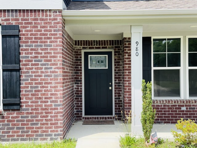 980 S Raylee Garden Dr, New Palestine, IN 46163 - doorway to property with brick siding, a porch, and roof with shingles