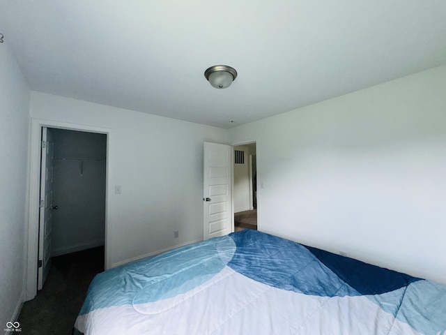 980 S Raylee Garden Dr, New Palestine, IN 46163 - bedroom with a walk in closet and dark colored carpet