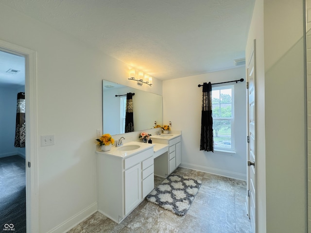 980 S Raylee Garden Dr, New Palestine, IN 46163 - bathroom featuring double vanity and a textured ceiling