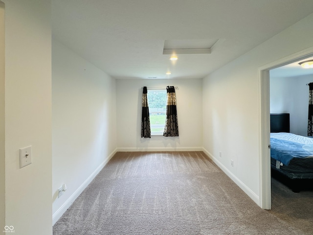 980 S Raylee Garden Dr, New Palestine, IN 46163 - unfurnished room featuring attic access and carpet