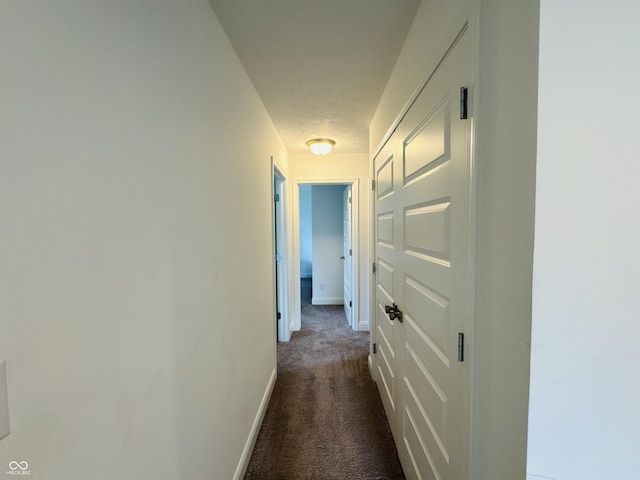 980 S Raylee Garden Dr, New Palestine, IN 46163 - hallway featuring dark carpet and baseboards
