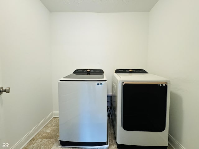 980 S Raylee Garden Dr, New Palestine, IN 46163 - laundry area featuring washing machine and clothes dryer and baseboards