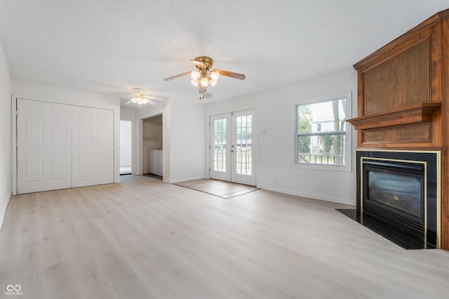 321 W Broad St, Spiceland, IN 47385 - unfurnished living room featuring a fireplace, light wood-type flooring, french doors, and a ceiling fan