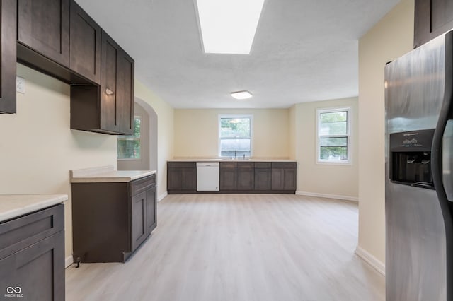 321 W Broad St, Spiceland, IN 47385 - kitchen with stainless steel fridge, white dishwasher, dark brown cabinets, light wood-style flooring, and light countertops