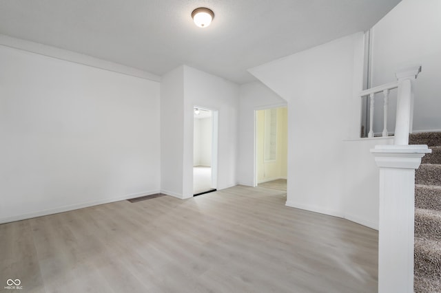 321 W Broad St, Spiceland, IN 47385 - unfurnished living room featuring wood finished floors and baseboards