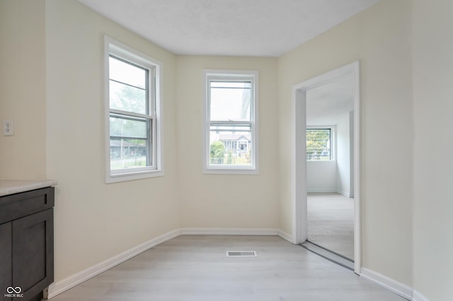 321 W Broad St, Spiceland, IN 47385 - unfurnished dining area with light wood-style flooring and baseboards
