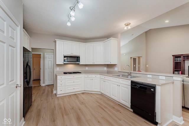 11074 Galley Way, Fishers, IN 46040 - kitchen with black appliances, a peninsula, light wood-type flooring, white cabinets, and track lighting