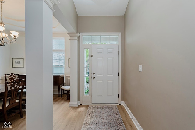 11074 Galley Way, Fishers, IN 46040 - entrance foyer featuring light wood-type flooring, a chandelier, and decorative columns