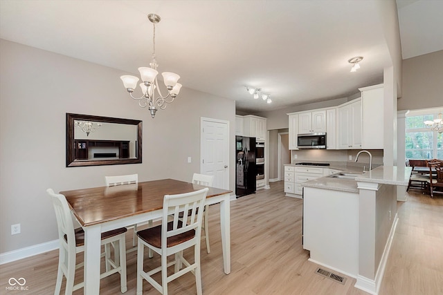 11074 Galley Way, Fishers, IN 46040 - kitchen with a chandelier, appliances with stainless steel finishes, light wood-type flooring, and a peninsula
