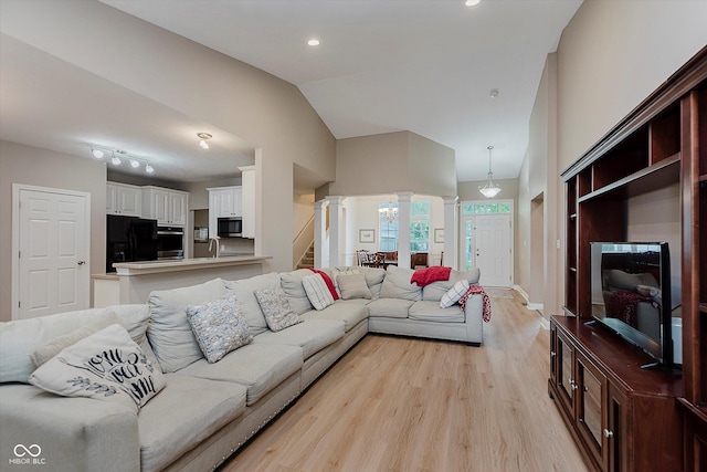 11074 Galley Way, Fishers, IN 46040 - living area featuring ornate columns, light wood-style flooring, vaulted ceiling, and recessed lighting