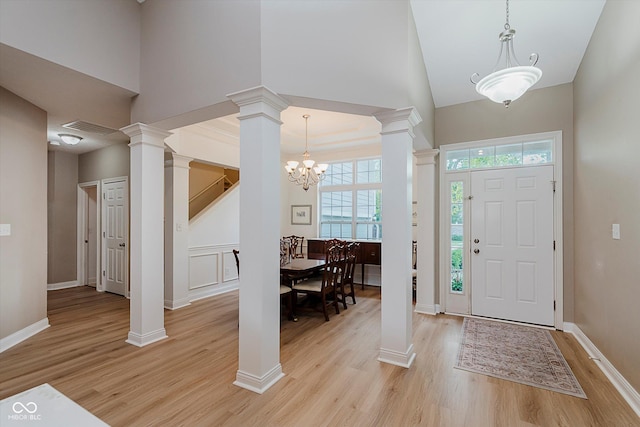 11074 Galley Way, Fishers, IN 46040 - entryway featuring light wood-type flooring, a high ceiling, a chandelier, and ornate columns