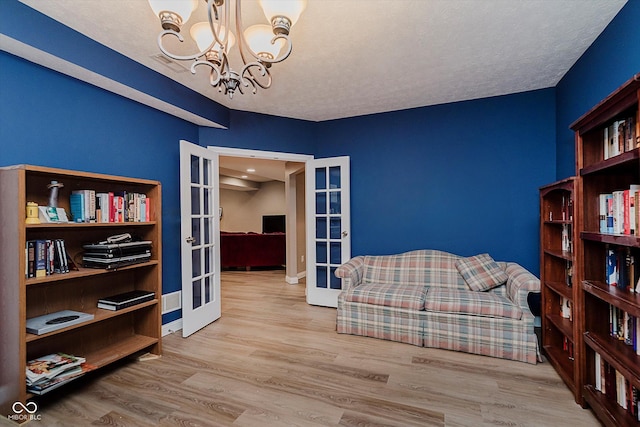 11074 Galley Way, Fishers, IN 46040 - sitting room with french doors, a chandelier, wood finished floors, and a textured ceiling
