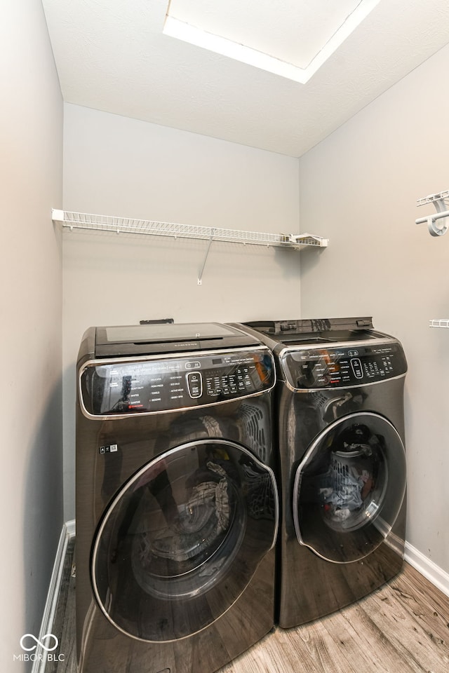 9053 Fitzgerald Dr, Indianapolis, IN 46239 - laundry room featuring independent washer and dryer and wood finished floors