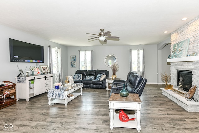 9053 Fitzgerald Dr, Indianapolis, IN 46239 - living room with ceiling fan, wood finished floors, a stone fireplace, and recessed lighting