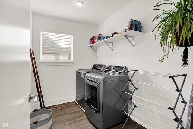 2720 Guilford Ave, Indianapolis, IN 46205 - laundry room featuring washer and dryer and wood finished floors