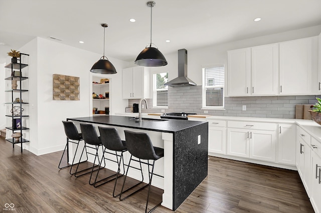 2720 Guilford Ave, Indianapolis, IN 46205 - kitchen with wall chimney exhaust hood, tasteful backsplash, dark wood-style flooring, and recessed lighting