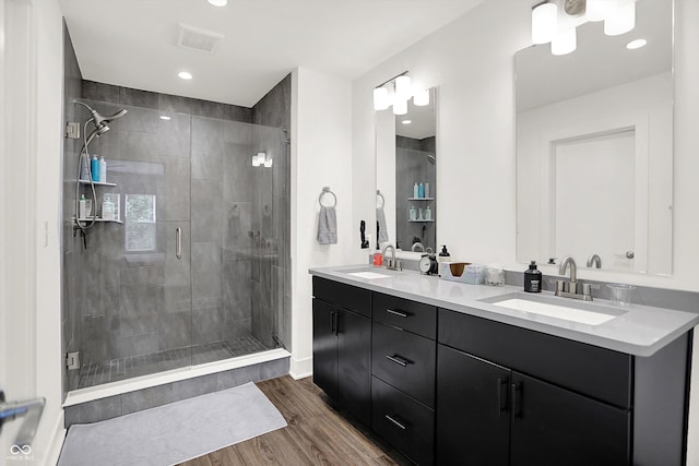 2720 Guilford Ave, Indianapolis, IN 46205 - full bath featuring wood finished floors, a stall shower, double vanity, and recessed lighting