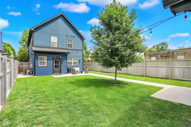 2720 Guilford Ave, Indianapolis, IN 46205 - rear view of property featuring an outdoor hangout area, a patio area, and a fenced backyard