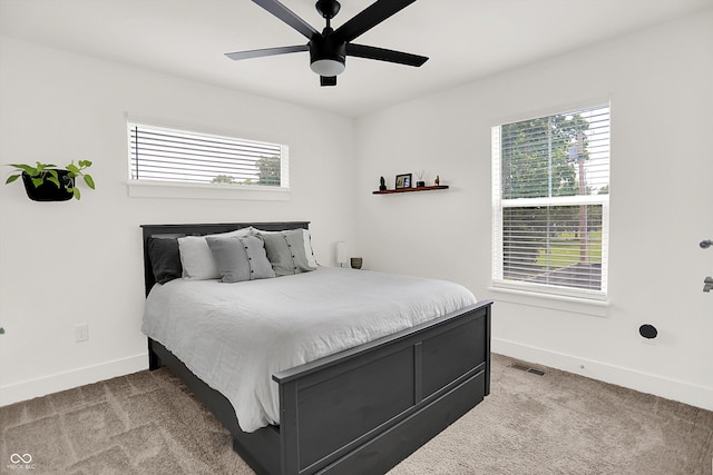2720 Guilford Ave, Indianapolis, IN 46205 - bedroom featuring light carpet, multiple windows, and a ceiling fan
