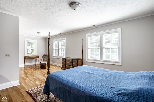4904 N Washington Blvd, Indianapolis, IN 46205 - bedroom featuring ornamental molding, wood finished floors, and a textured ceiling