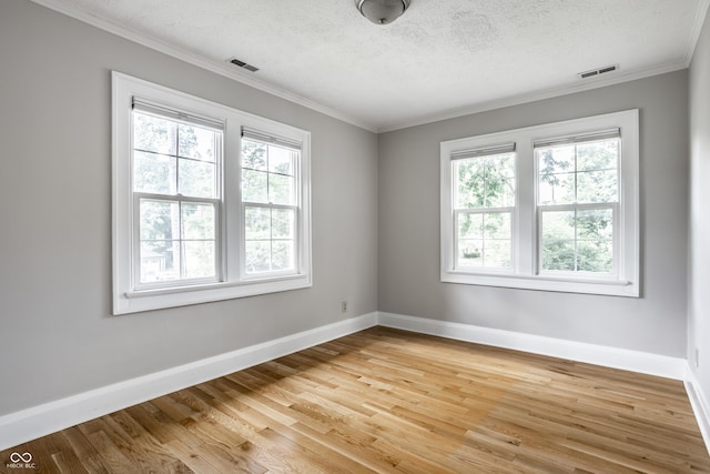 4904 N Washington Blvd, Indianapolis, IN 46205 - unfurnished room with healthy amount of natural light, light wood-type flooring, crown molding, and a textured ceiling