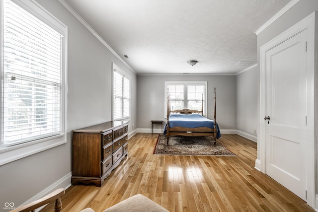 4904 N Washington Blvd, Indianapolis, IN 46205 - bedroom featuring ornamental molding, light wood finished floors, and a textured ceiling