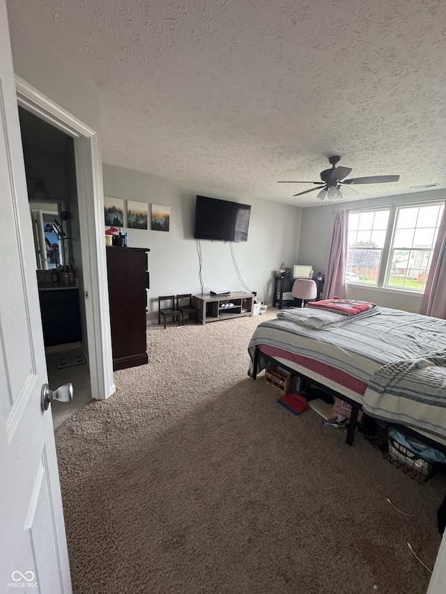6027 Moonseed Cir, Indianapolis, IN 46203 - carpeted bedroom with a textured ceiling and a ceiling fan