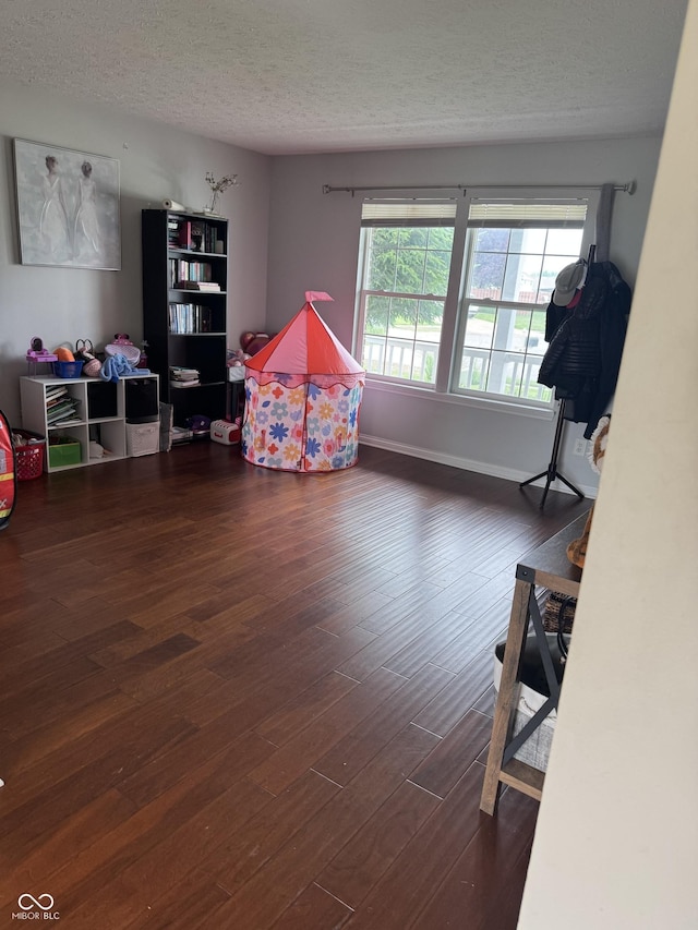 6027 Moonseed Cir, Indianapolis, IN 46203 - game room featuring a textured ceiling and wood finished floors