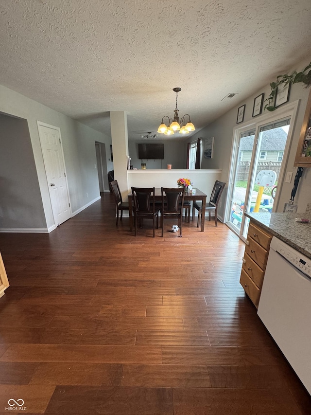 6027 Moonseed Cir, Indianapolis, IN 46203 - dining space featuring a chandelier, dark wood-style flooring, and a textured ceiling