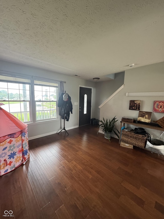 6027 Moonseed Cir, Indianapolis, IN 46203 - foyer entrance with a textured ceiling and wood finished floors