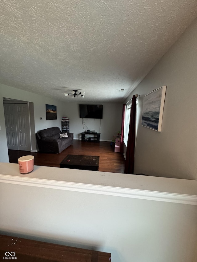6027 Moonseed Cir, Indianapolis, IN 46203 - living room featuring a textured ceiling and wood finished floors