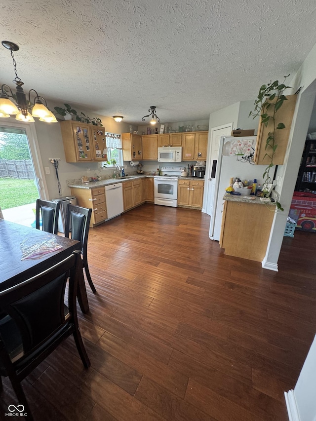6027 Moonseed Cir, Indianapolis, IN 46203 - kitchen with white appliances, a chandelier, light countertops, dark wood-style floors, and a textured ceiling