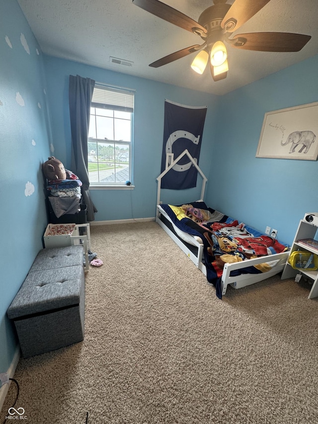 6027 Moonseed Cir, Indianapolis, IN 46203 - carpeted bedroom featuring a ceiling fan and a textured ceiling