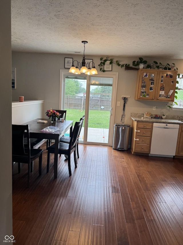 6027 Moonseed Cir, Indianapolis, IN 46203 - dining space featuring a chandelier, a textured ceiling, healthy amount of natural light, and dark wood-style floors