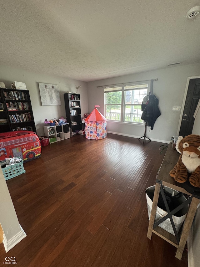6027 Moonseed Cir, Indianapolis, IN 46203 - recreation room featuring a textured ceiling and wood finished floors