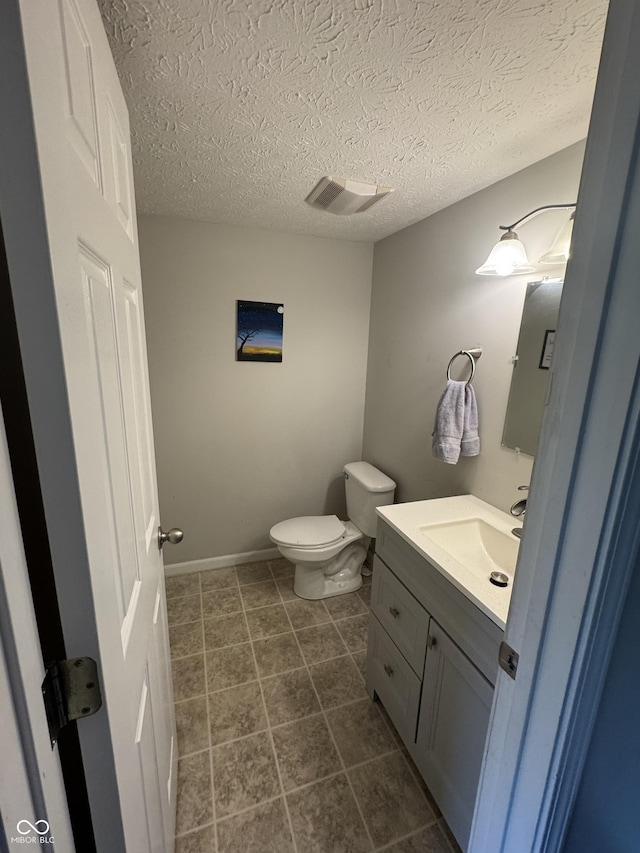 6027 Moonseed Cir, Indianapolis, IN 46203 - bathroom with vanity, a textured ceiling, and tile patterned floors