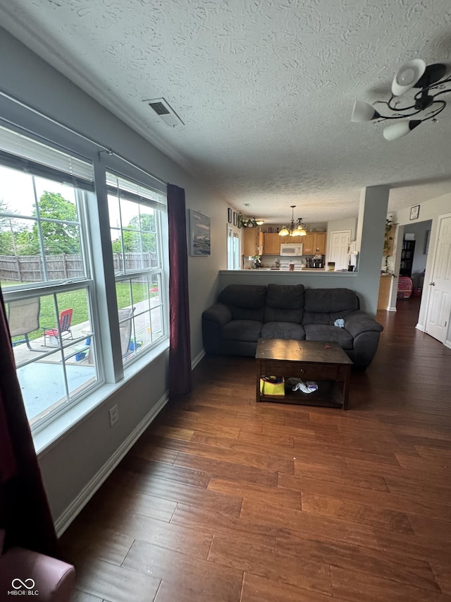 6027 Moonseed Cir, Indianapolis, IN 46203 - living area with a textured ceiling and dark wood-style flooring